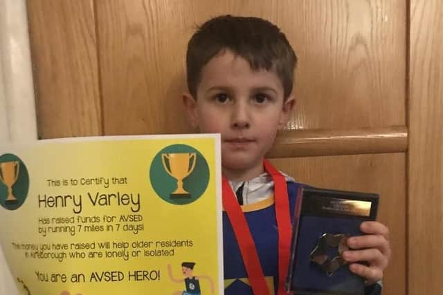 Henry Varley with his certificate, award and medal from Aireborough Voluntary Services to the Elderly (AVSED) after he raised £700 for the charity.