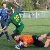 Wykebeck Arms goalkeeper Adam Wilson saves from Ash Parker of Hunslet Club Sundays First. Picture: Steve Riding.