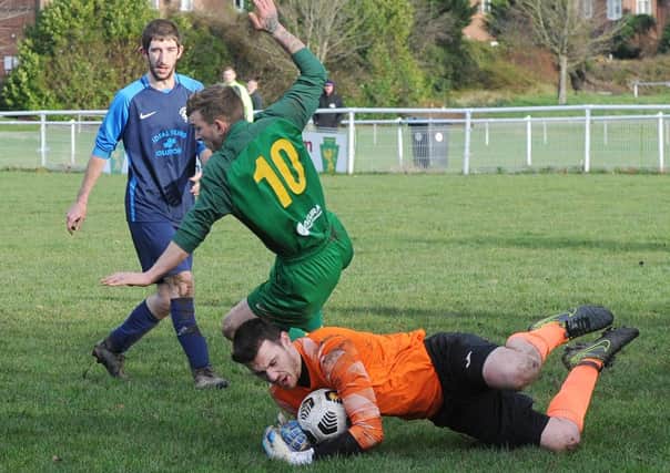 Wykebeck Arms goalkeeper Adam Wilson saves from Ash Parker of Hunslet Club Sundays First. Picture: Steve Riding.