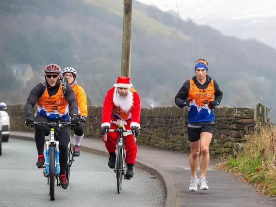 Kevin Sinfield and his support team, including ex-Rhinos star Barrie McDermott, left, during the last of this month's marathons. Picture by Bruce Rollinson.