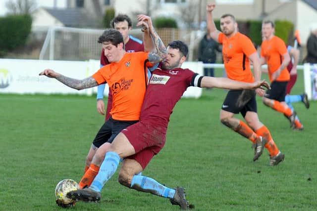 Aiden Barry, right of Rawdon, and Otley Town's Ryan Cox go toe to toe. Picture: Steve Riding.