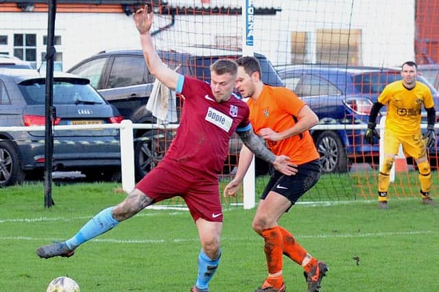 Paul Butler, of Rawdon, holds off Otley Town's Harry Leigh. Picture: Steve Riding.