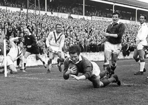 At the double: Wakefield Trinity centre Ian Brooke, watched by Don Fox, scores one of his two tries in the 1967 Rugby League Championship final replay victory over St Helens at Station Road, Swinton.