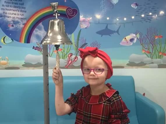 A young patient rings a bell to mark the end of her treatment at the end of the video (photo: still taken from Leeds Teaching Hospitals Christmas video)