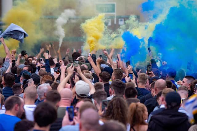 ELATION: Leeds United's fans gather outside Elland Road to finally celebrate the return to Premier League football after a 16-year wait following Huddersfield Town's 2-1 win at home to West Brom. Picture by Bruce Rollinson.