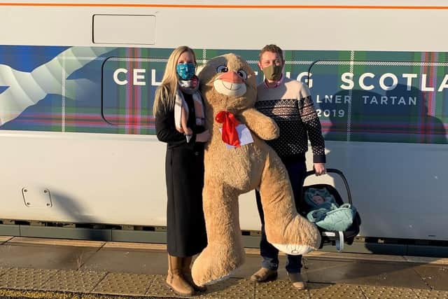 The Christmas bear with Major Tim and Dr Emily Barker at Leuchars Train Station.