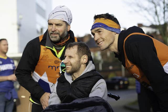 Rob Burrow, centre, greets Kevin Sinfield, right, and his running team after they completed seven marathons in seven days to raise funds for the Motor Neurone Disease Association. Picture: Allan McKenzie/SWpix.com