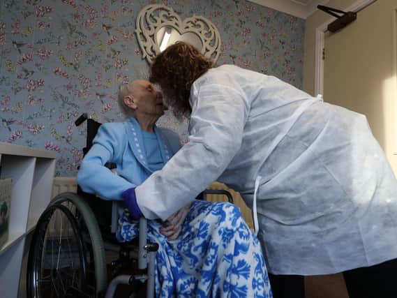 Diane Schofield embraces her friend Mary Kirby, who she affectionately calls Auntie Mary, during a Christmas Day visit at Aspen Hill Village care home in Hunslet, Leeds. Picture: Danny Lawson/PA Wire
