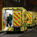 A paramedic opening the rear door of one of the ambulances queued outside the Royal London Hospital, in London. Photo: PA