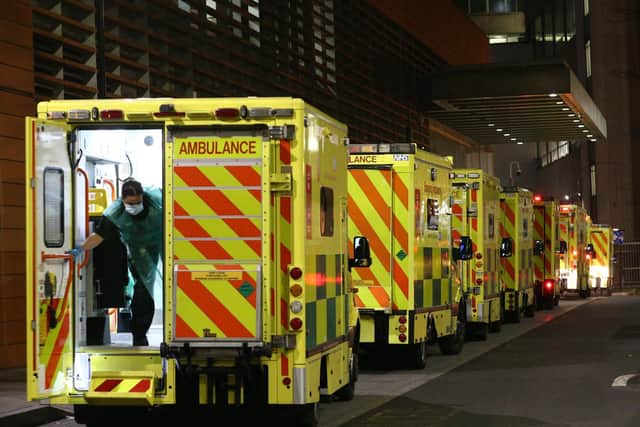 A paramedic opening the rear door of one of the ambulances queued outside the Royal London Hospital, in London. Photo: PA