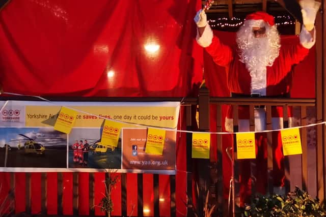 Santa on the decking of the Gaping Goose in Garforth waving to families.