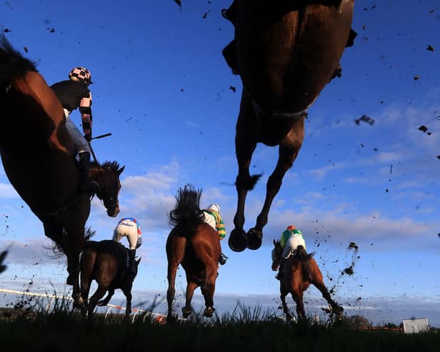 Runners and riders clear a fence at Wetherby - racing will continue to operate behind closed doors for the time being.