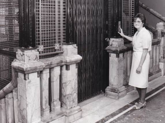 The ornate marble and gilt lift. Seen at the gate is Susan Dunwell, a cashier with Waring and Gillow in July 1985.