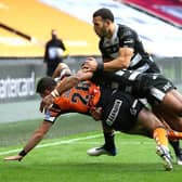 Brad Graham is tackled during his Tigers debut, against Hull, last year. Picture by Ash Allen/SWpix.com.