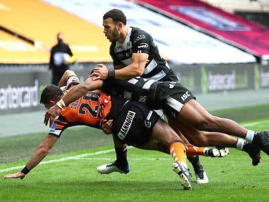 Brad Graham is tackled during his Tigers debut, against Hull, last year. Picture by Ash Allen/SWpix.com.