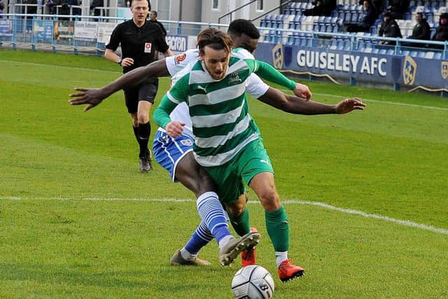 Luke Parkin of Farsley Celtic is brought down by Guiseley defender Chukwudalu Molokwu for a penalty during the Boxing Day clash between the sides at Nethermoor. Picture: Steve Riding.
