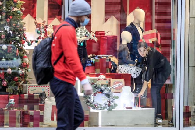 Library image of a woman adjusting  a window display at a Marks & Spencer store in Manchester