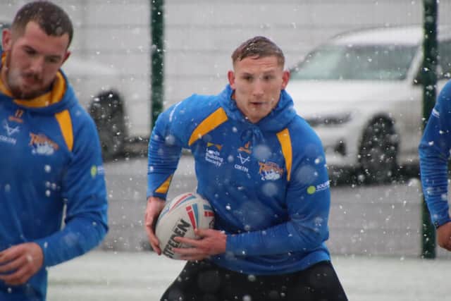 Mikolaj Oledzki, middle, trains alongside Cameron Smith during Friday's blizzard. Picture by Phil Daly.