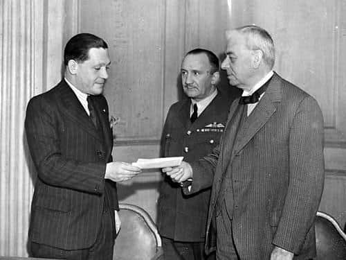 Frank Heywood, general manager of the Yorkshire Evening News hands over a cheque for £30,000 to the Lord Mayor of Leeds, Alderman C.H. Boyle, and Group Captain C.F. Horsley.