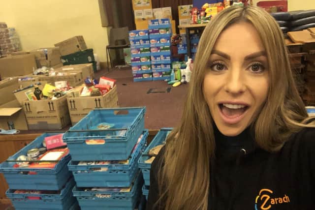 Zarach founder Bex Wilson is pictured next to crates of food destined to help struggling families in Leeds.