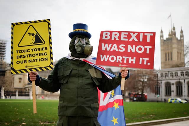 Anti-Brexit protester holds up sign reading 'Brexit was not worth it' outside Parliament. Picture: Getty