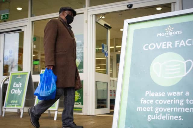 A shopper wearing a face mask outside a Morrisons store in south London. Supermarkets are being called on to revert to more stringent in-store coronavirus measures with members of the public urged to respect regulations when out grocery shopping.
PA Wire