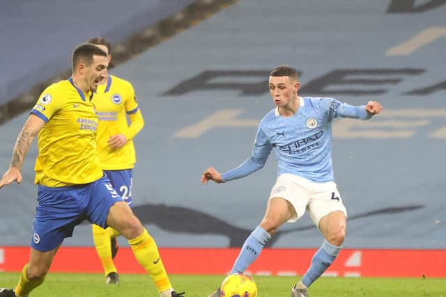DECIDER: Manchester City's Phil Foden, right, scores the only goal of the game under pressure from defender Lewis Dunk in Wednesday night's 1-0 victory against the Seagulls. Photo by Clive Brunskill/Getty Images.