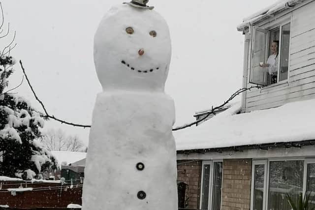 Jack, who is six foot three, was tasked with completing Willy’s head and was hoisted up in the air by his mum who held a small step ladder by the base of the snowman (photo: SWNS)