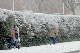 A family walks in the snow in Whitkirk on Thursday
