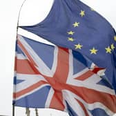 Library image of Union and EU flags flying outside the Palace of Westminster,