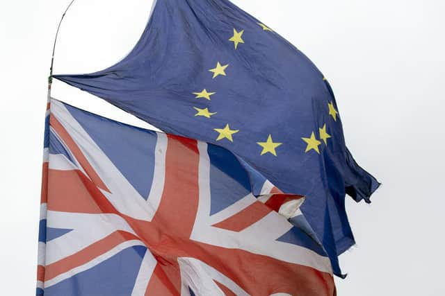 Library image of Union and EU flags flying outside the Palace of Westminster,