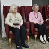 Care assistant Sam Maybury chats to residents Audrey Sykes,86, and Vivienne Aitkin, 91, before their vaccination at Alexandra Court Care Home, in Leeds.