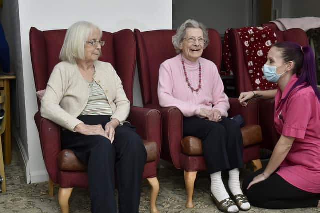 Alexandra Court care home care assistant  Sam Maybury chats to residents Audrey Sykes, 86, and Vivienne Aitkin, 91, before their  first Covid-19 vaccinations. 

Photo; Steve Riding