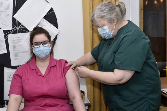 Matron Liz Davies, of Burton Croft Surgery, Headingley, gives the vaccine to Alexandra Court care home care assistant Chaise Friend.

Photo: Steve Riding