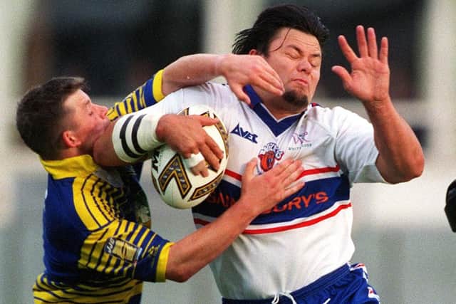 Wakefield's Tony Kemp is tackled by the Warrington defence. Picture: James Hardisty.