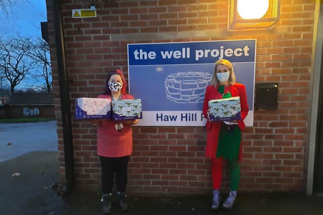 Youth worker Lauren Allen, left, with a donation of selection boxes from WDH Cashwise.