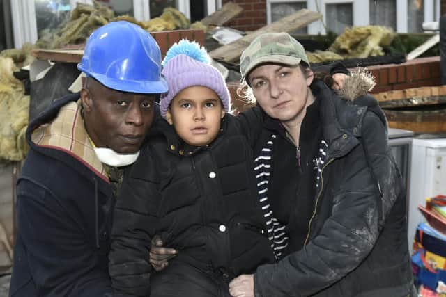 Llowell Williams and partner Edyta Wlodek with their their five year old daughter  daughter Cassitta outside their fire damaged home in Chapel Allerton.

Photo: Steev Riding