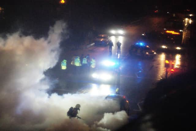 Firefighters extinguish the blazing car. Picture by John Blow.