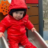 Spencer enjoys a trip to the playground in the waterproofs funded by University of Leeds researchers. Picture: Home-Start Leeds