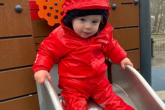Spencer enjoys a trip to the playground in the waterproofs funded by University of Leeds researchers. Picture: Home-Start Leeds