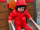 Spencer enjoys a trip to the playground in the waterproofs funded by University of Leeds researchers. Picture: Home-Start Leeds