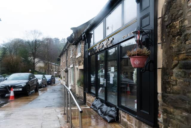 Sandbags and flood defence walls have been set up by Whalley residents and business owners. Photo: Kelvin Stuttard