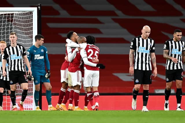 RALLYING CRY: From Newcastle United captain Jamaal Lascelles, right, pictured heading back to the centre circle after Pierre-Emerick Aubameyang's second goal in Arsenal's 3-0 victory at The Emirates. Photo by Shaun Botterill/Getty Images.