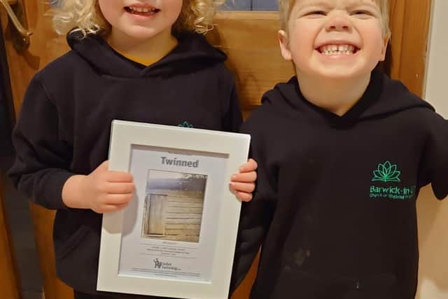 Bea and Milo, the grandchildren of SI Wakefield president Linda Phillips, with one of the toilet twinning certificates.