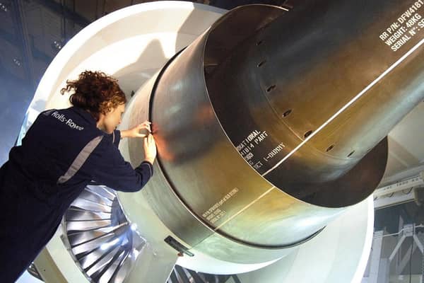 Rolls-Royce photo of a female worker inspecting a Trent 1000 engine.