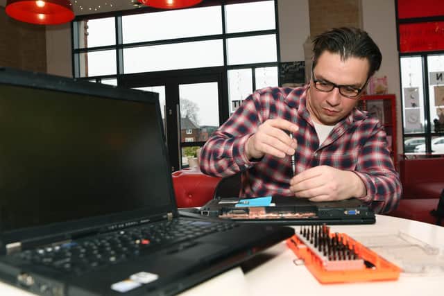 Ben McKenna of Leeds Tech Angels gets to work on re-purposing laptops for handing out to schools.
