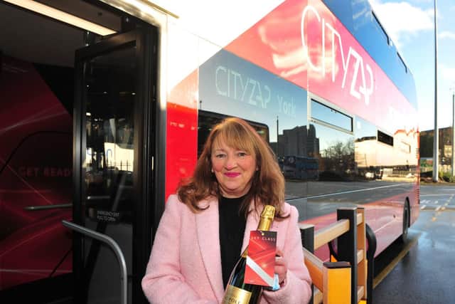 West Yorkshire Transport Committee Chair Cllr. Kim Groves with a champagne welcome pack given to the first lucky customers on board Transdev’s new £1.4m Cityzap buses.