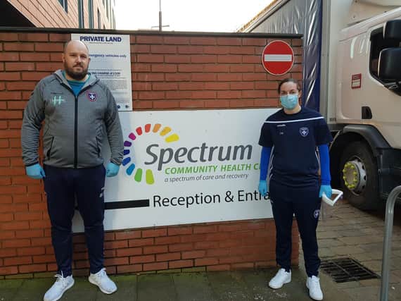 Craig Fisher, of Trinity Community Foundation and Wakefield Trinity Ladies FC footballer Emily Wright at the vaccination centre.