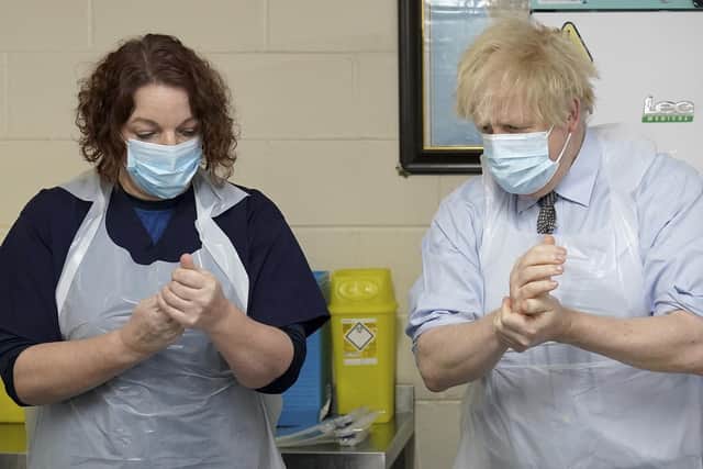 Prime Minister Boris Johnson is shown how to prepare the vaccine by advance nurse practitioner Sarah Sowden during a visit to a coronavirus vaccination centre in Batley, West Yorkshire (photo: PA Wire/ Jon Super)