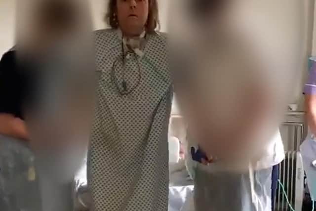Jason Kelk takes his first steps using a walking frame at St James' Hospital.